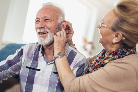 hearing aid on older man